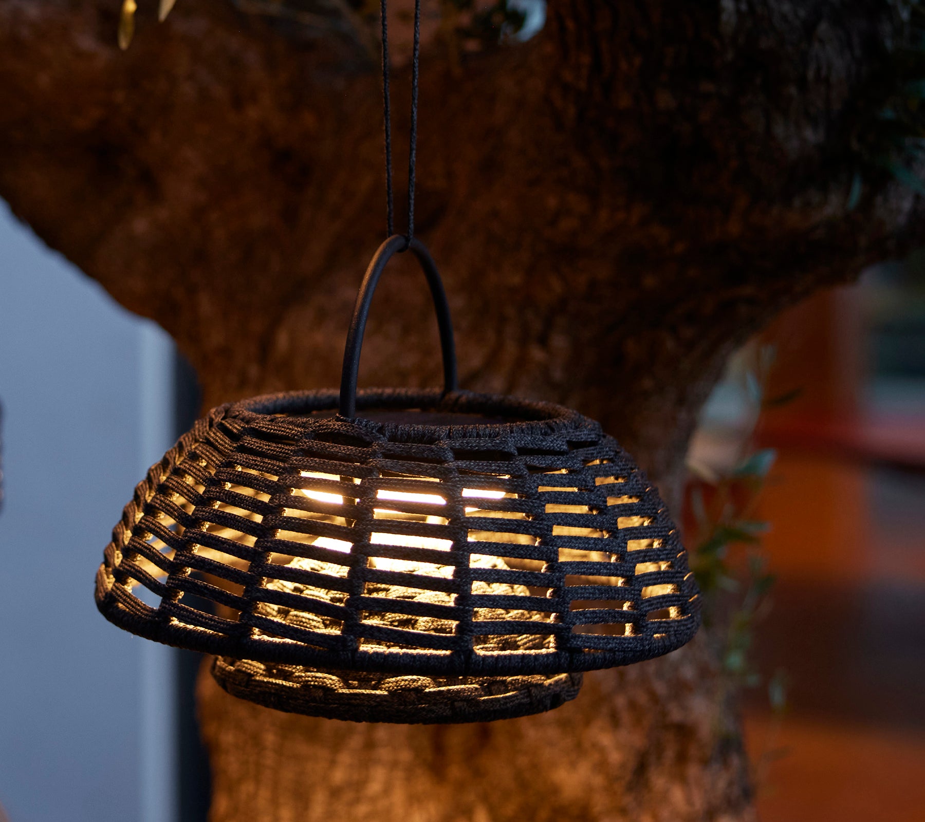 Hanging illusion lamp with an intricate woven design and warm LED light, creating a cozy ambiance.