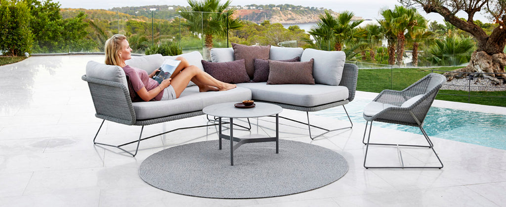 Modern lounge area with spacious and elegant outdoor lounge sofa and modern coffee tables 