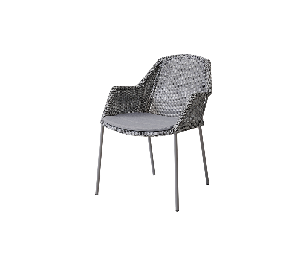 Gray woven chair with armrests and a light cushion, designed for comfort and style in various settings.