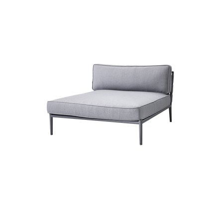 Gray upholstered lounge chair with a minimalist design and a sleek metal frame, featuring a backrest and spacious seating area.