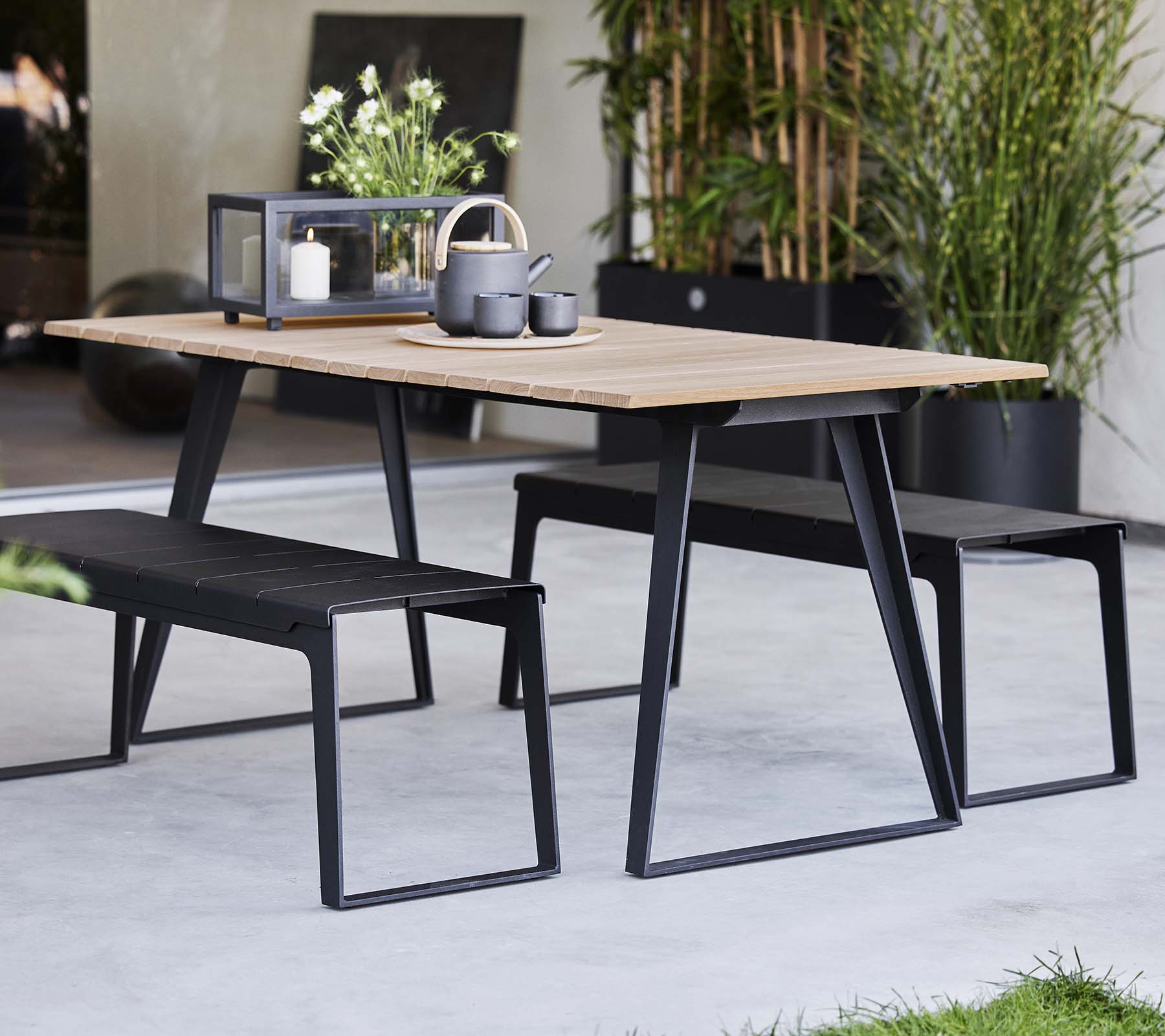 Stylish Copenhagen table paired with matching benches, featuring a modern design and minimalist decor elements.