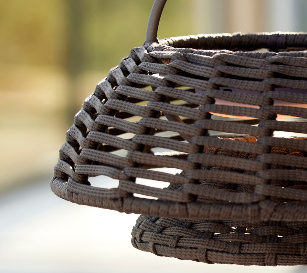 Close-up of a taupe illusion lamp featuring a woven design, showcasing intricate lattice patterns and textured materials.